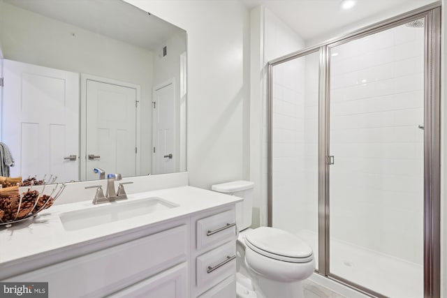 bathroom featuring vanity, toilet, and walk in shower