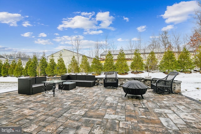 view of patio / terrace featuring an outdoor living space with a fire pit