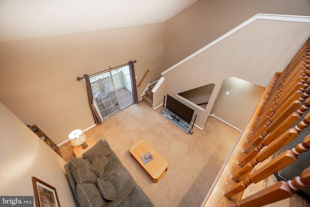 carpeted living room with vaulted ceiling