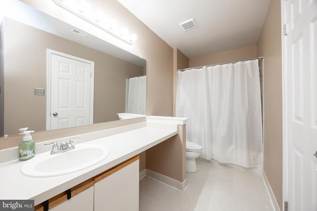 bathroom with tile patterned floors, vanity, and toilet