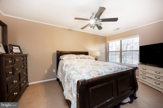 carpeted bedroom with ceiling fan and crown molding