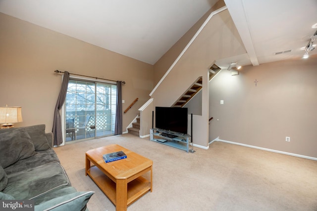 carpeted living room featuring rail lighting and vaulted ceiling