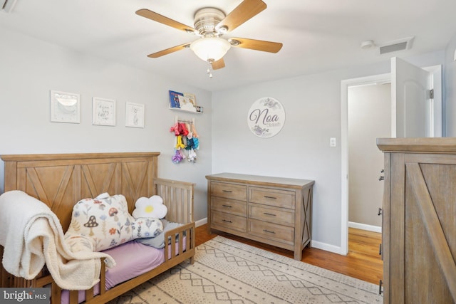 bedroom with ceiling fan and light hardwood / wood-style flooring