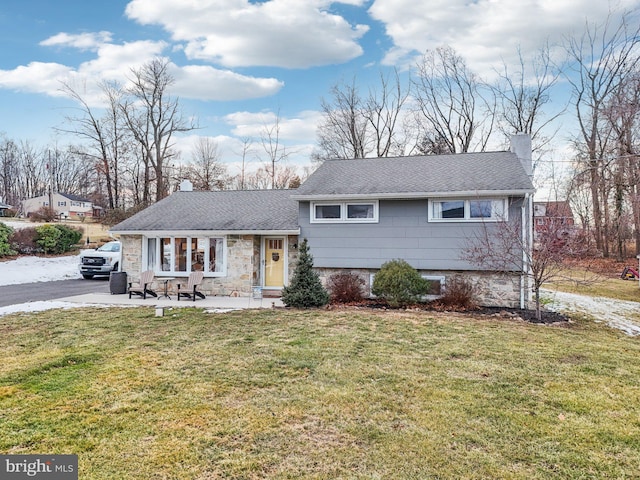 tri-level home with a front yard