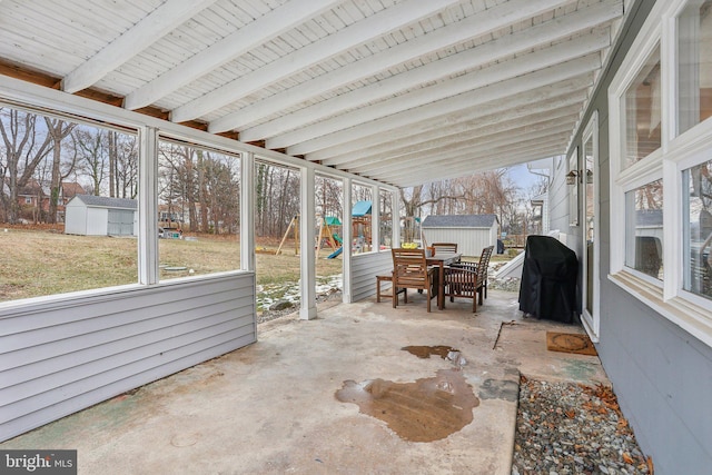 view of patio / terrace with grilling area and a storage shed