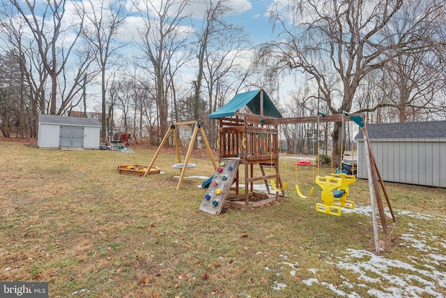 view of play area featuring a yard and a storage unit