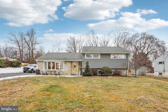 split level home with a front lawn