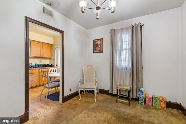 living area featuring carpet floors and a chandelier