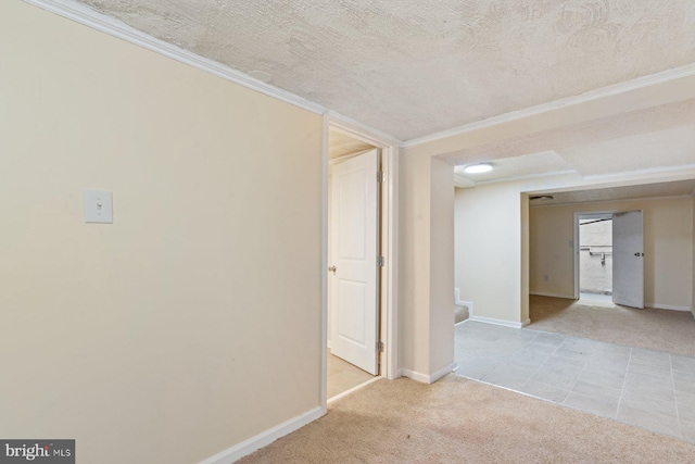 carpeted spare room with crown molding and a textured ceiling