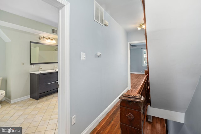 bathroom featuring tile patterned flooring, vanity, and toilet