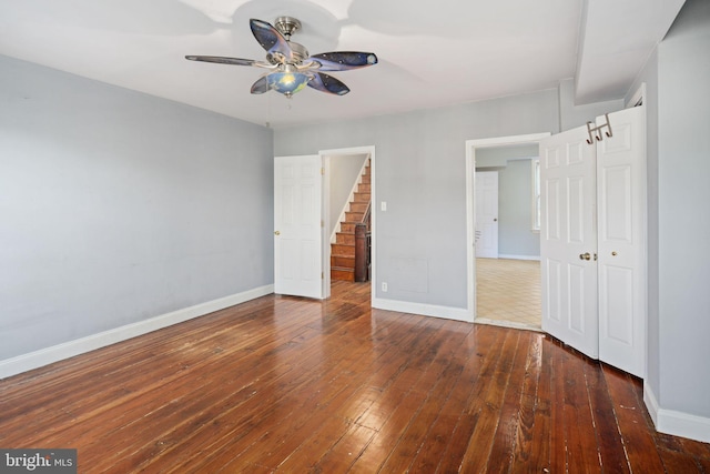 unfurnished bedroom featuring dark hardwood / wood-style flooring and ceiling fan