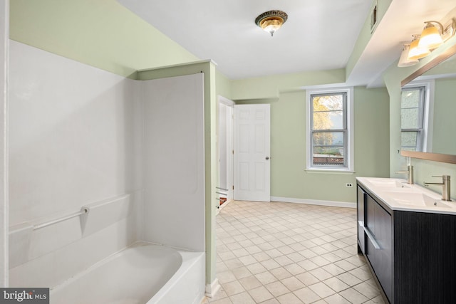 bathroom featuring tile patterned flooring, vanity, and  shower combination