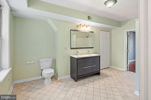 bathroom with tile patterned floors, vanity, and toilet