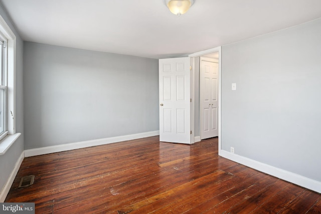 unfurnished room featuring dark hardwood / wood-style floors