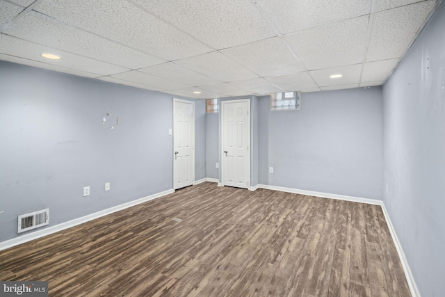 basement with wood-type flooring and a drop ceiling