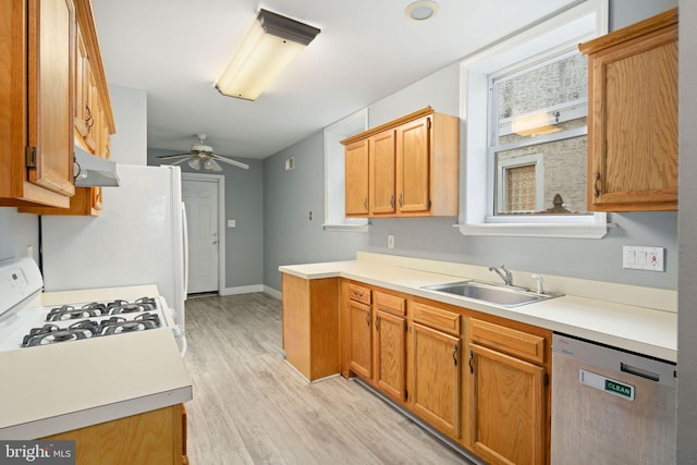 kitchen with ceiling fan, white gas stove, dishwasher, sink, and plenty of natural light