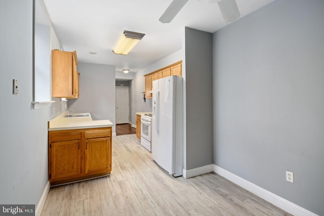 kitchen featuring light hardwood / wood-style floors, white appliances, and sink