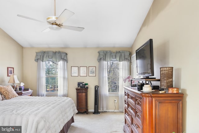 carpeted bedroom featuring ceiling fan and vaulted ceiling