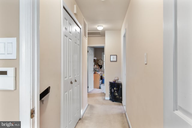 hallway with light colored carpet