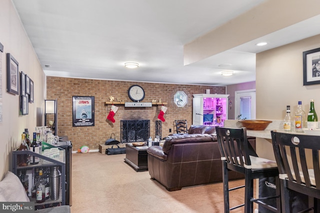 carpeted living room featuring a fireplace and brick wall