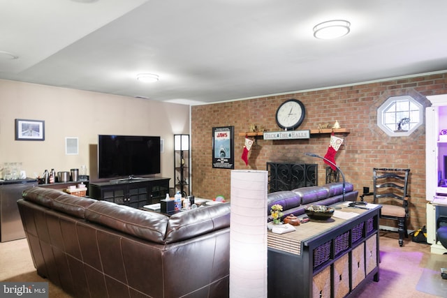 carpeted living room featuring brick wall and a brick fireplace