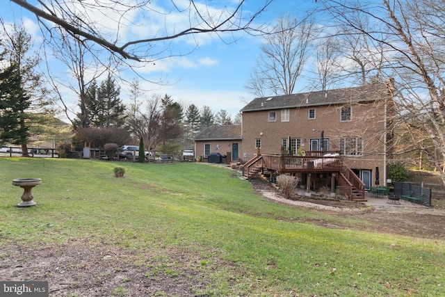 exterior space featuring a lawn and a wooden deck