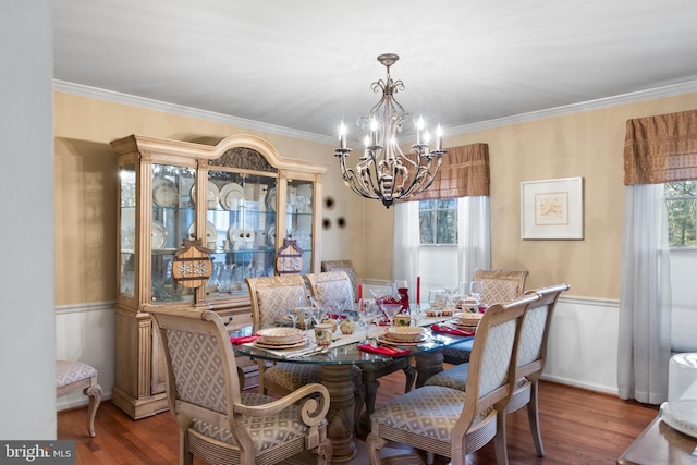 dining space featuring a chandelier, hardwood / wood-style flooring, and crown molding