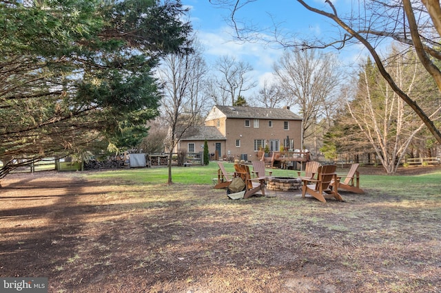 view of yard featuring a storage shed and an outdoor fire pit