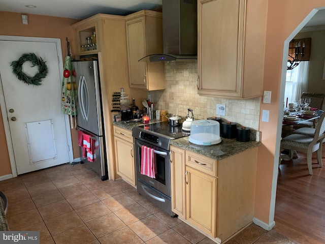 kitchen with light brown cabinetry, light tile patterned floors, wall chimney range hood, and appliances with stainless steel finishes