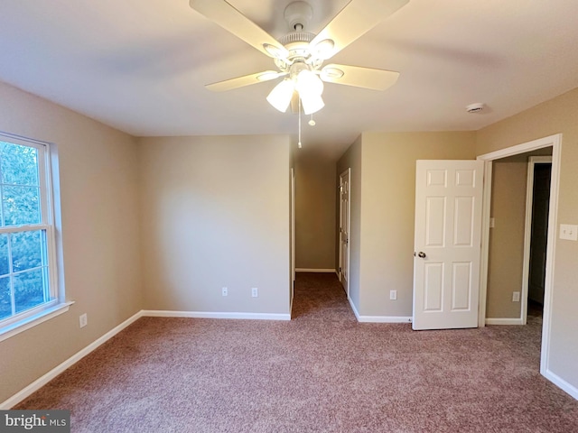 unfurnished bedroom with ceiling fan and carpet