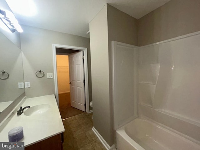 full bathroom with toilet, vanity, and washtub / shower combination