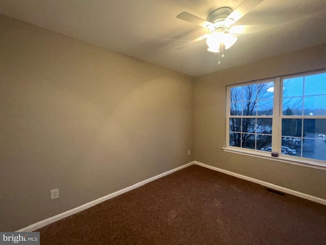 carpeted empty room featuring ceiling fan