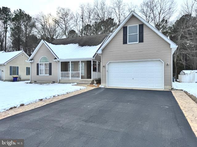 view of front of house featuring a garage and covered porch