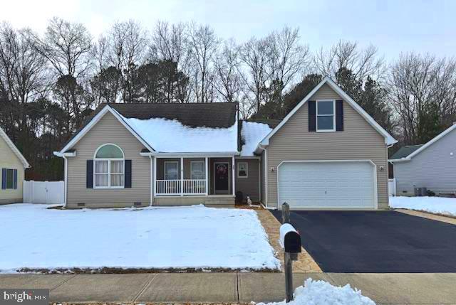 view of front of home featuring a garage and a porch