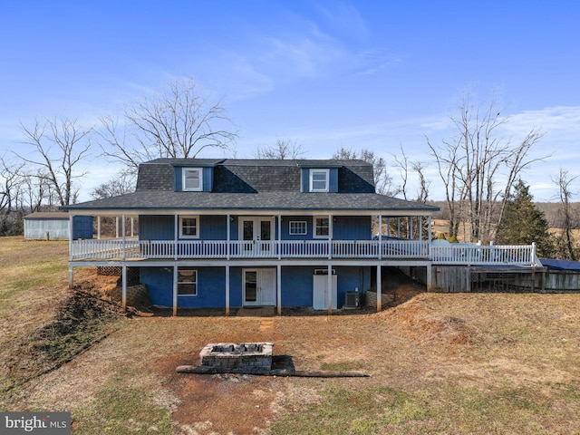 back of house with central AC unit and a deck