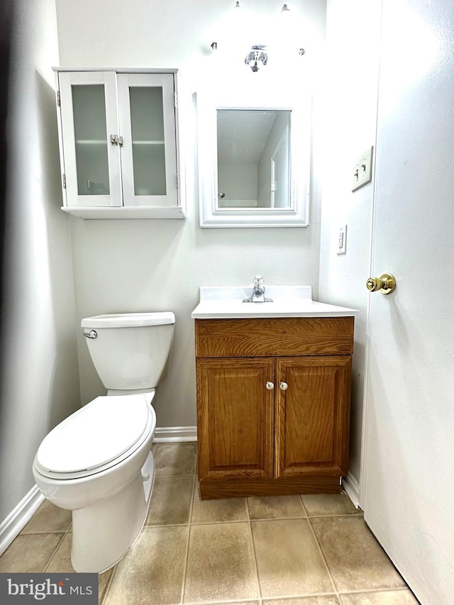 bathroom featuring toilet, vanity, and tile patterned floors