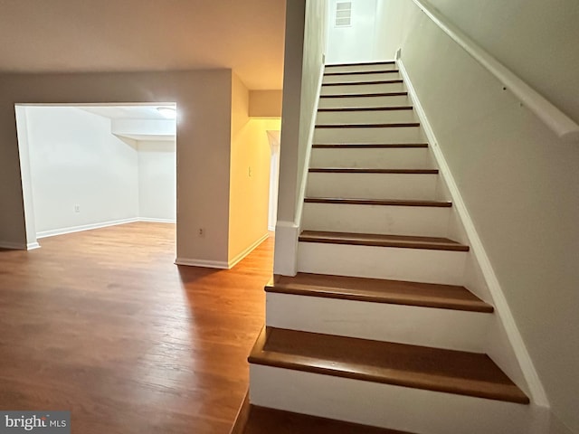 staircase featuring hardwood / wood-style flooring