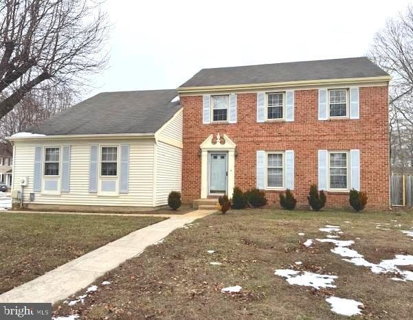 colonial inspired home with a front lawn