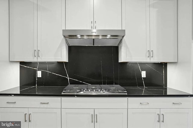 kitchen featuring decorative backsplash, white cabinetry, and stainless steel gas cooktop