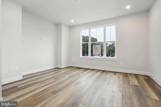 unfurnished room with light hardwood / wood-style flooring