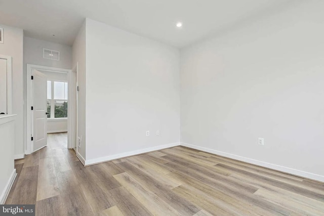 spare room with light hardwood / wood-style flooring