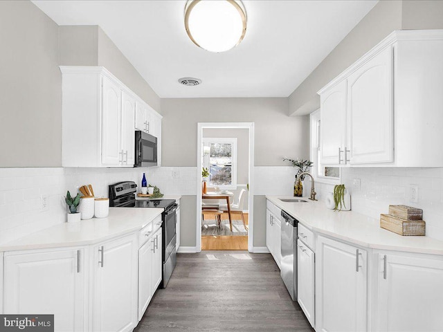 kitchen featuring white cabinets, dark hardwood / wood-style flooring, stainless steel appliances, and sink