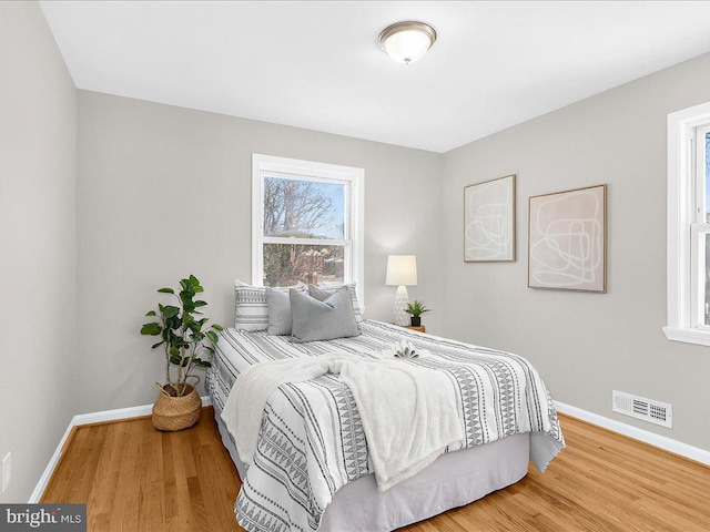 bedroom with hardwood / wood-style flooring