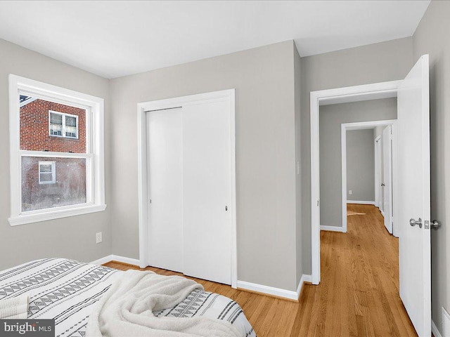 bedroom featuring light wood-type flooring and a closet