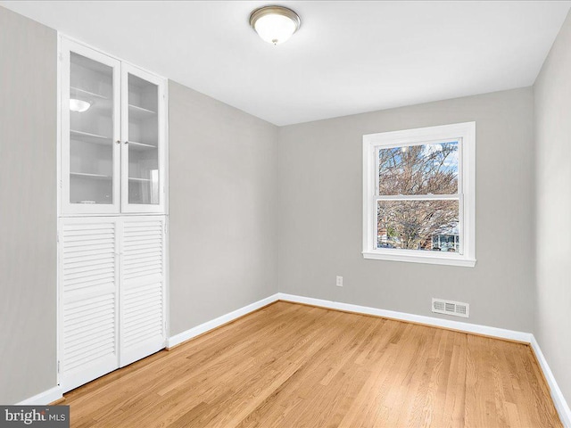 unfurnished room featuring hardwood / wood-style flooring