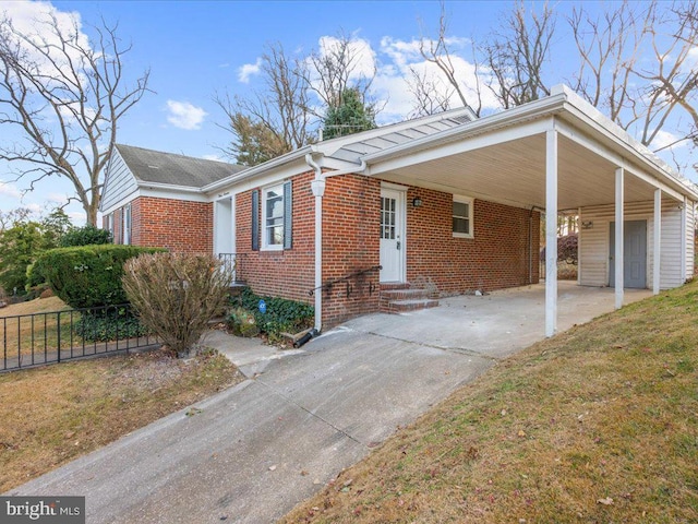 view of front facade with a front yard and a carport