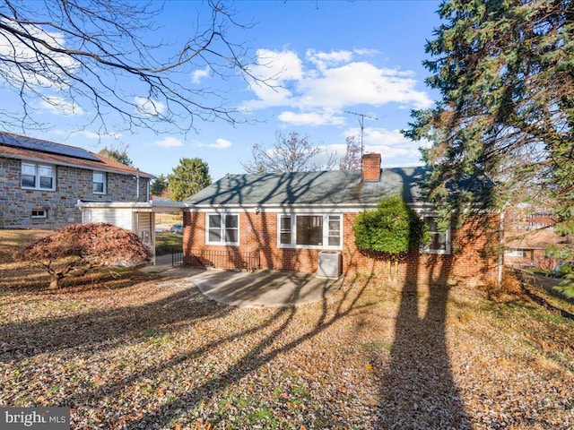 back of house featuring a yard and a patio