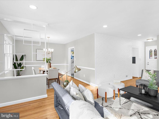 living room featuring a chandelier and light hardwood / wood-style flooring