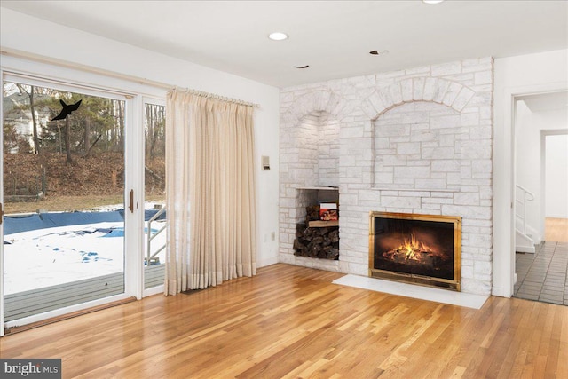 unfurnished living room with a fireplace and wood-type flooring