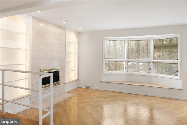 unfurnished living room with light parquet floors